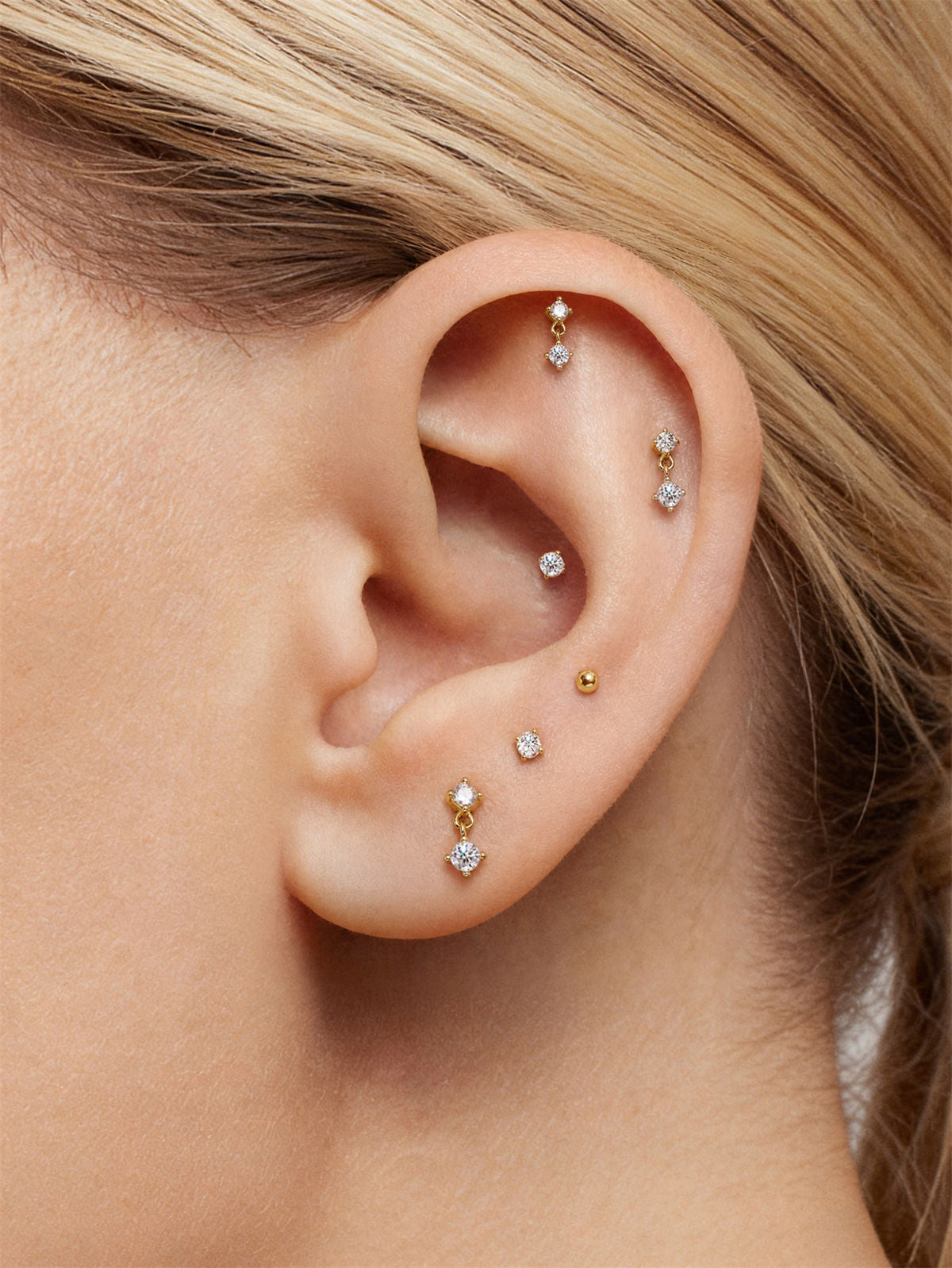 KOSINER 14K gold drop flat back stud worn in multiple ear piercings, helix lobe tragus curated ear stack with dangle CZ piercing earrings