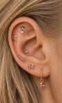 Layered full ear stack with KOSINER Orchard fruit studs and rainbow ear climber, pineapple, banana, purple cherry flat cartilage piercings match rainbow curved crawler earring