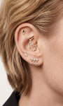 Edgy personalized full ear stacking look featuring KOSINER Prism spliced marquise flat back stud, matched spike dangle studs, chain conch piercing jewelry, pave cz helix piercings, modern sharp-line multi-position ear styling