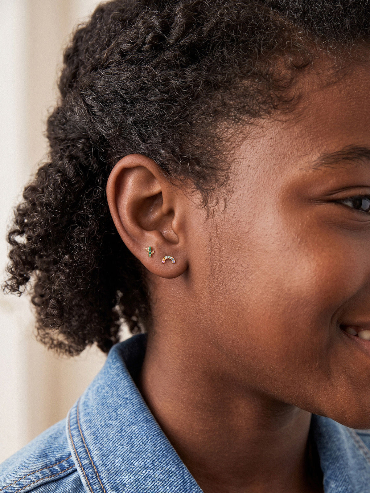 Model wearing the Little Wonder 14K gold cactus flat back stud in an ear stack