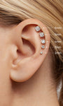 Close-up ear photo showing vertical helix stack of KOSINER lab-grown diamond flat back studs in sizes 2mm through 6mm, clearly labeled diameters for cartilage piercing size reference