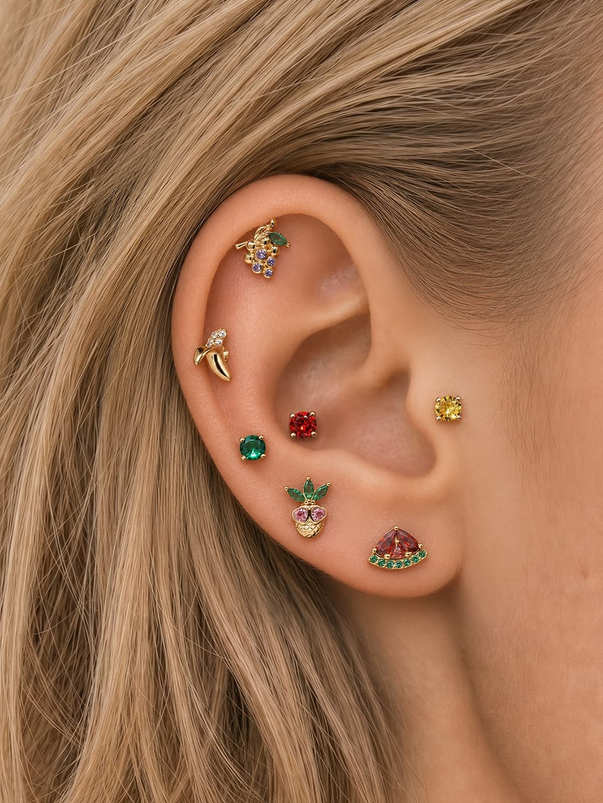 Full layered ear stack of KOSINER Orchard fruit collection, banana flat stud matched with grape, pineapple, watermelon, solid gem cartilage piercing earrings