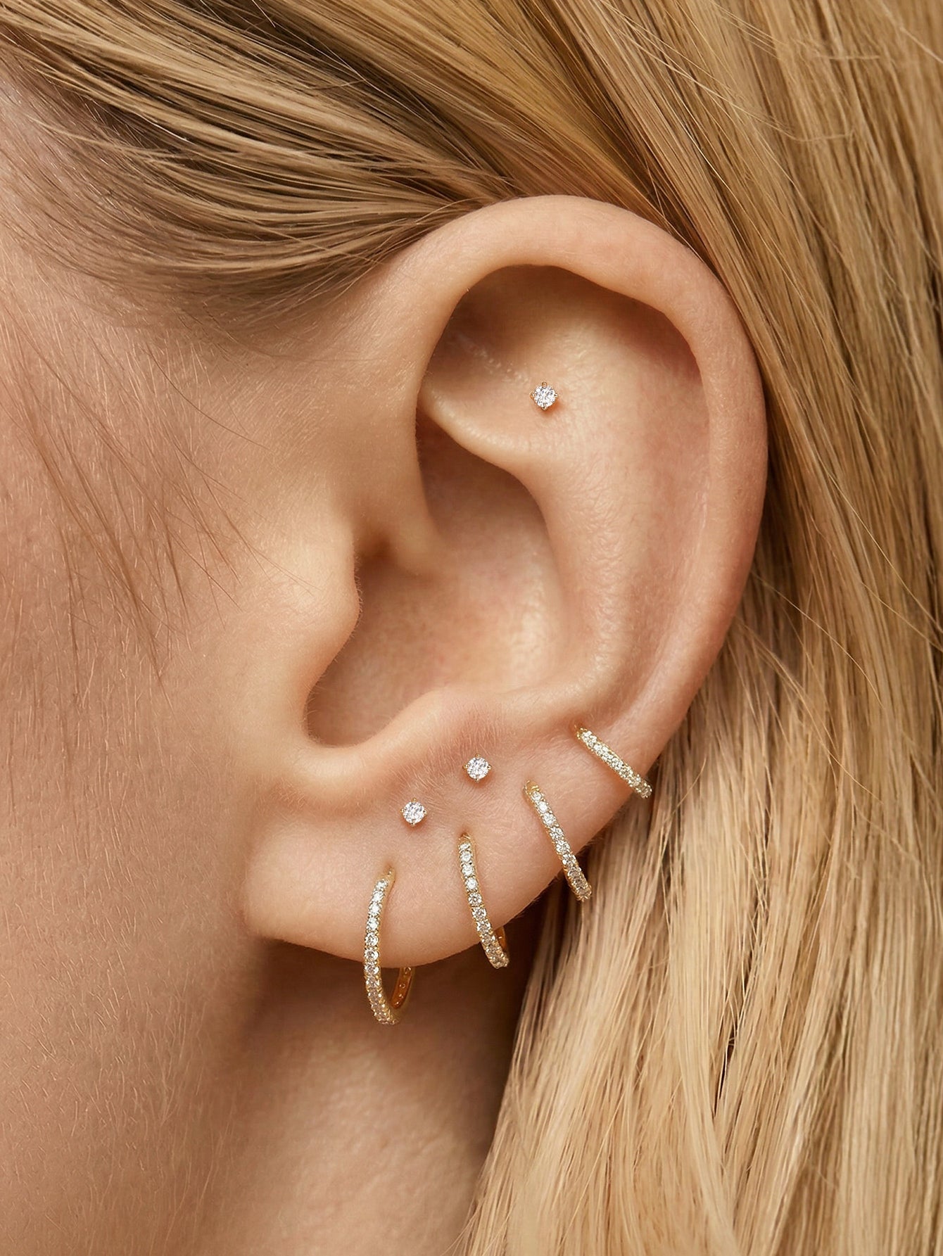 KOSINER elegant silver earrings featuring intricate geometric designs, perfect for adding a touch of sophistication to any outfit.