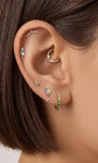 Layered full ear stack styling with KOSINER Gem Garden natural gem series, pear peridot daith clicker hoop matched with three-tone triangle, aquamarine dangle, emerald mini flat back studs