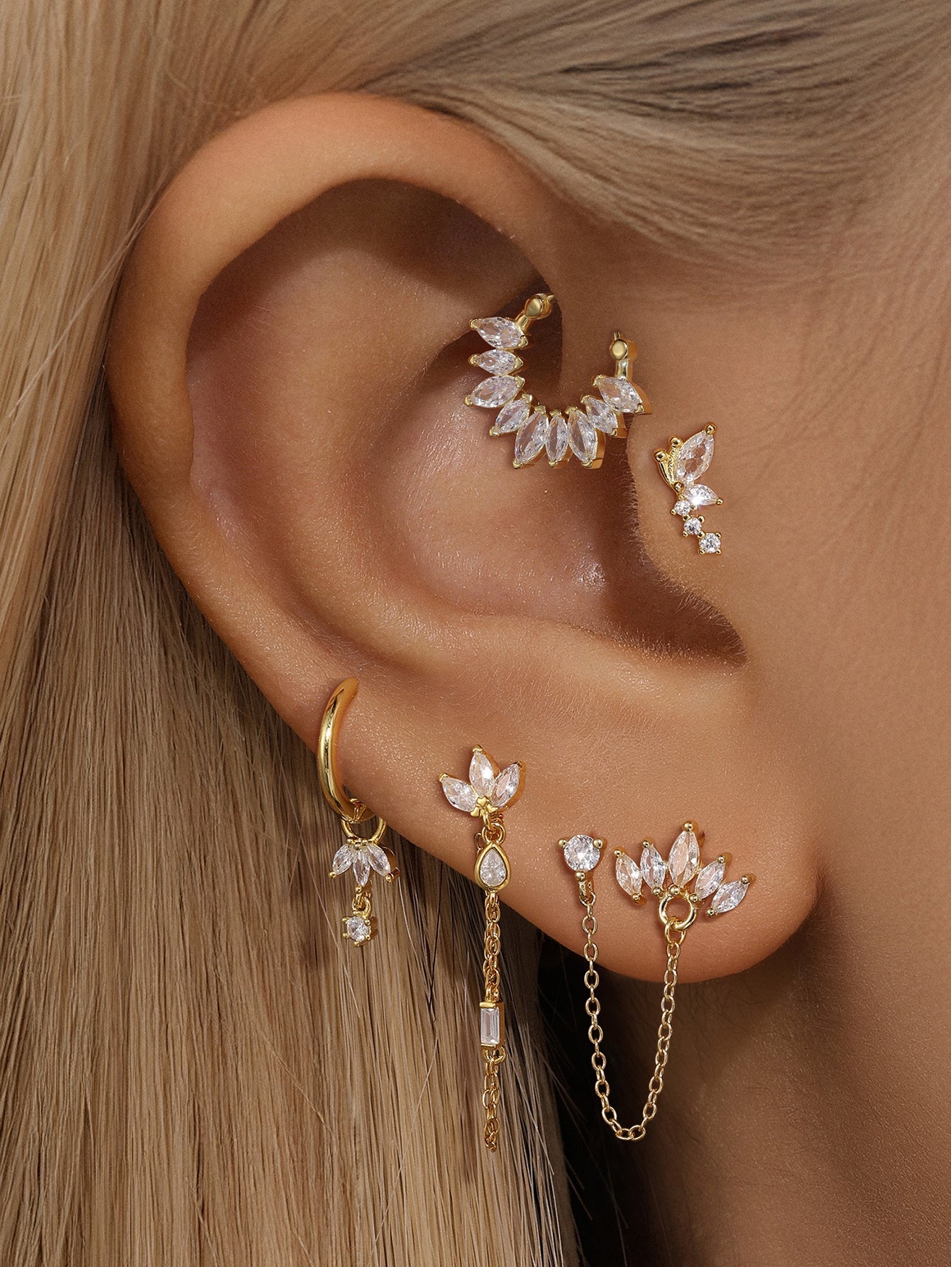 Gold plated sterling silver CZ earrings set: cuff, butterfly stud, chain hoop, and matching studs on ear.