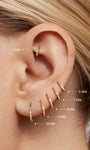 Close-up ear photo displaying stacked KOSINER diamond clicker hoops in sizes 5mm, 6mm, 7mm, 8mm, 9mm, 10mm worn along helix and lobe piercings for size reference