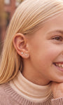 Model wearing the Little Wonder 14K gold rabbit flat back stud in an ear stack