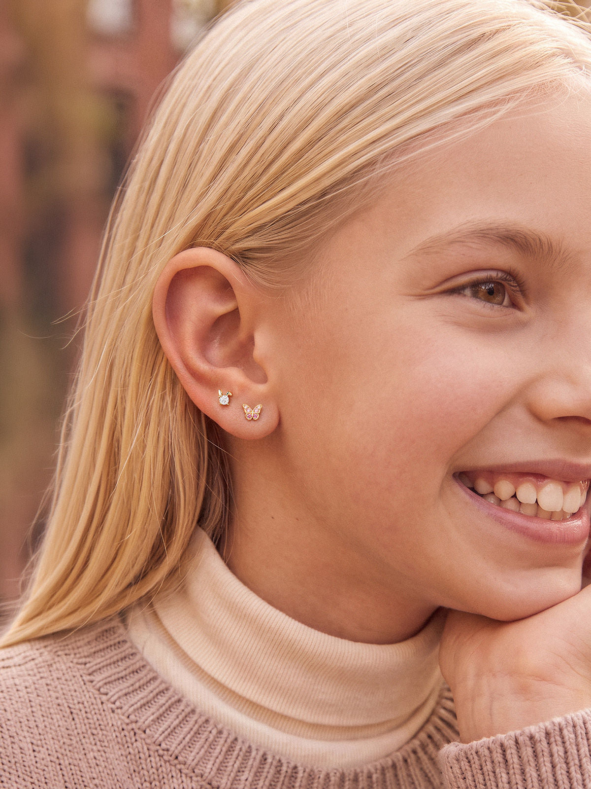 Model wearing the Little Wonder 14K gold rabbit flat back stud in an ear stack