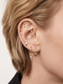 Edgy layered full ear stack styling with KOSINER triple rhombus spike drop hoop, paired pointed spike studs, starburst rook hoop, dangle helix piercings, minimalist punk geometric ear stacking aesthetic for lobe & helix piercings