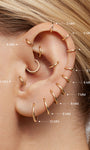 Curated full ear stacking showcase with KOSINER 14K solid gold minimalist hoops, labeled with corresponding diameters (4mm-10mm) for different helix, conch, lobe piercing placements