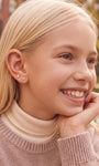 Model wearing the Little Wonder 14K gold butterfly flat back stud in an ear stack