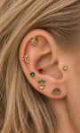 Layered full ear stack styling of KOSINER Orchard fruit jewelry line, purple grape flat stud matched with banana, pineapple, watermelon, round solitaire gem cartilage piercings