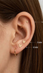 KOSINER 14K solid gold heart stud worn solo or layered in curated ear stack
