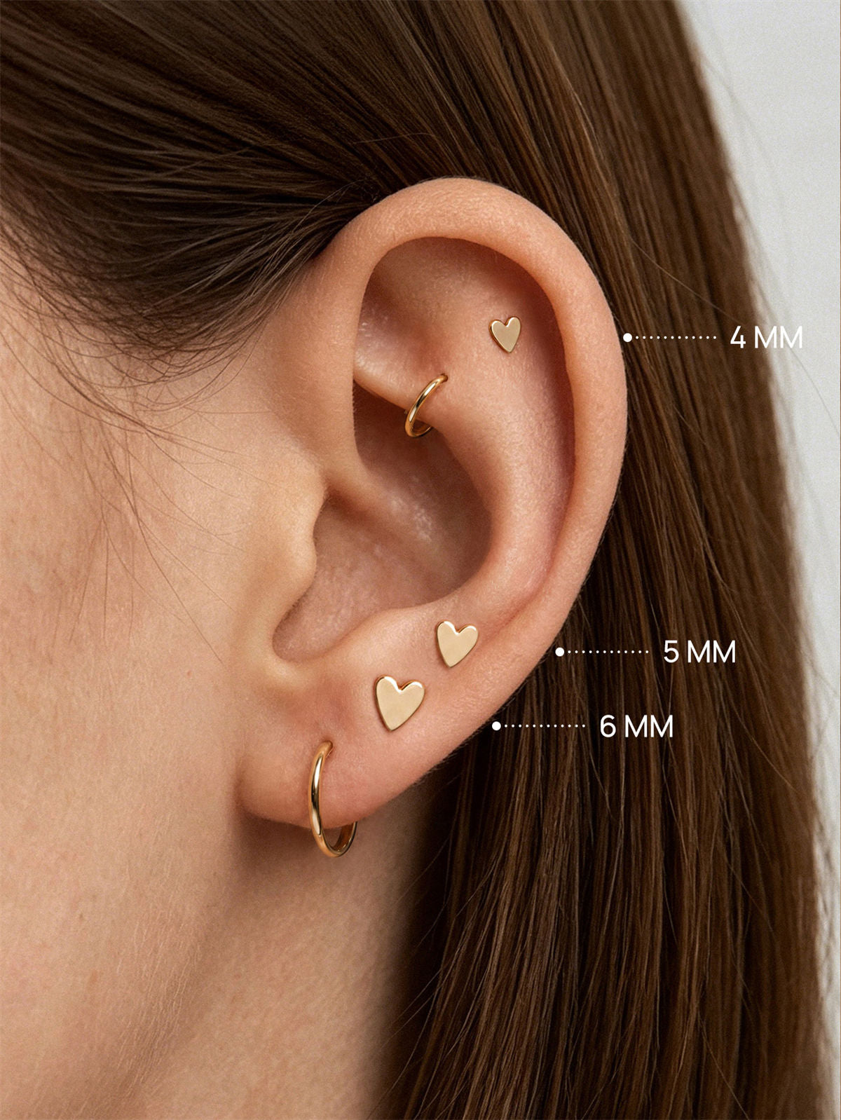 KOSINER 14K solid gold heart stud worn solo or layered in curated ear stack