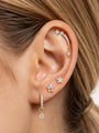 KOSINER Rising Star gold-plated star earring worn on the upper ear with matching star studs and a hoop