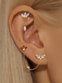 Gold plated sterling silver Red Flaming Wings pendant earrings with red & clear cubic zirconia, styled on ear.