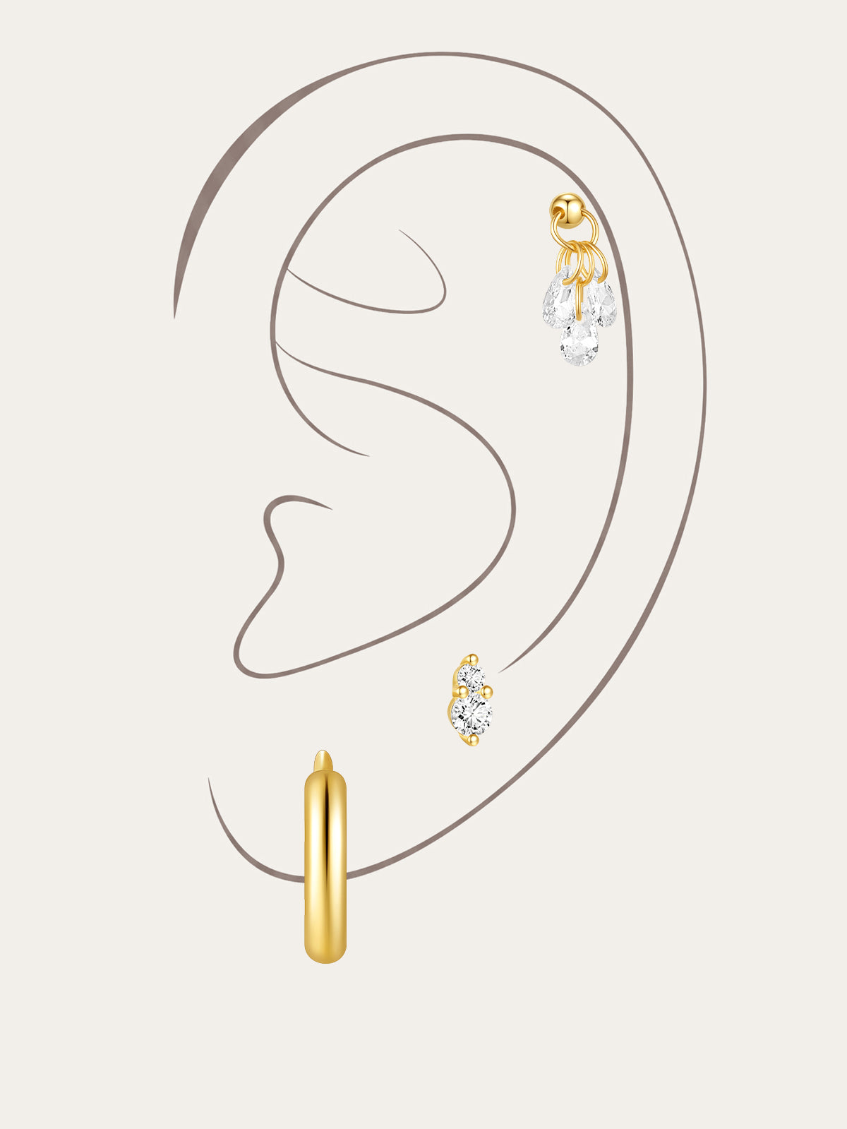 Collection of gold sterling silver earrings with cubic zirconia, including hoops and studs, styled on an ear.