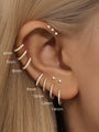 Gold sterling silver huggie hoop earrings with cubic zirconia, showing size variations from 6mm to 14mm on ear.