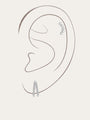925 sterling silver ear stack with cubic zirconia studs, pavé hoop, and drop earring with square zircon, shown on ear.