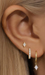 Model wearing 3-piece 18k gold-plated earrings: stud, hoop, and dangle, featuring quadrilateral cubic zirconia.