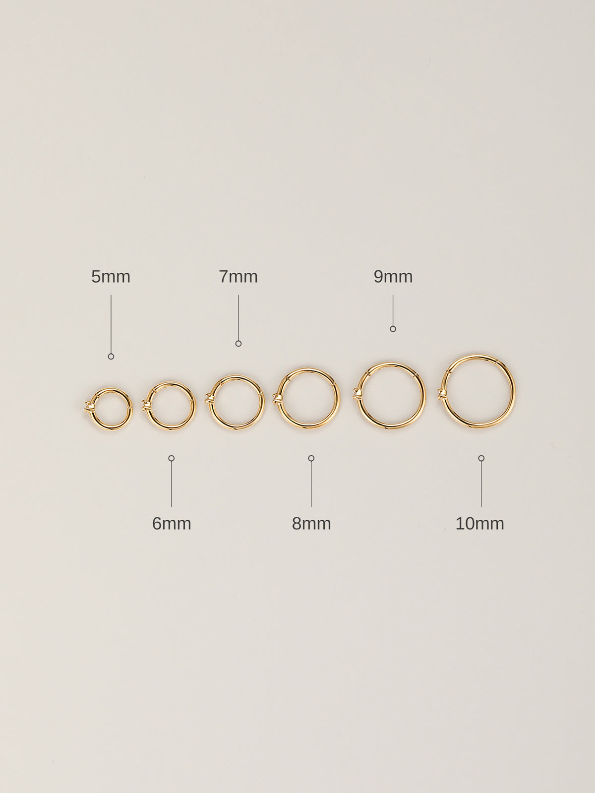 Top-down flat lay showing full size lineup of KOSINER diamond clicker hoops: 5mm, 6mm, 7mm, 8mm, 9mm, 10mm diameter labeled clearly on neutral light background