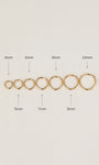 Horizontal size arrangement of KOSINER 14K solid gold minimalist clicker hoops, clearly marked 4mm to 10mm outer diameters for size selection reference on neutral white backdrop