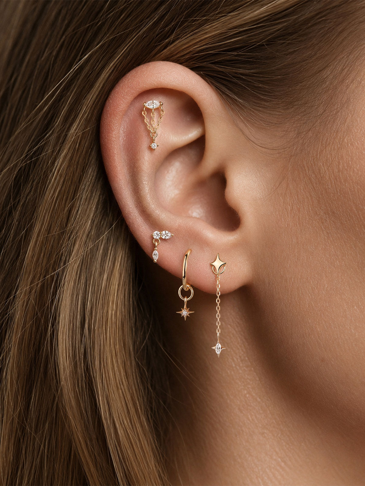 Close up curated ear stack, 14K solid gold marquise cut cz star long chain dangle charm, minimalist gold piercing accessories
