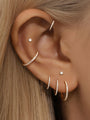 Titanium 16g/18g cartilage hoop earrings with CZ stones in multiple sizes worn on ear.