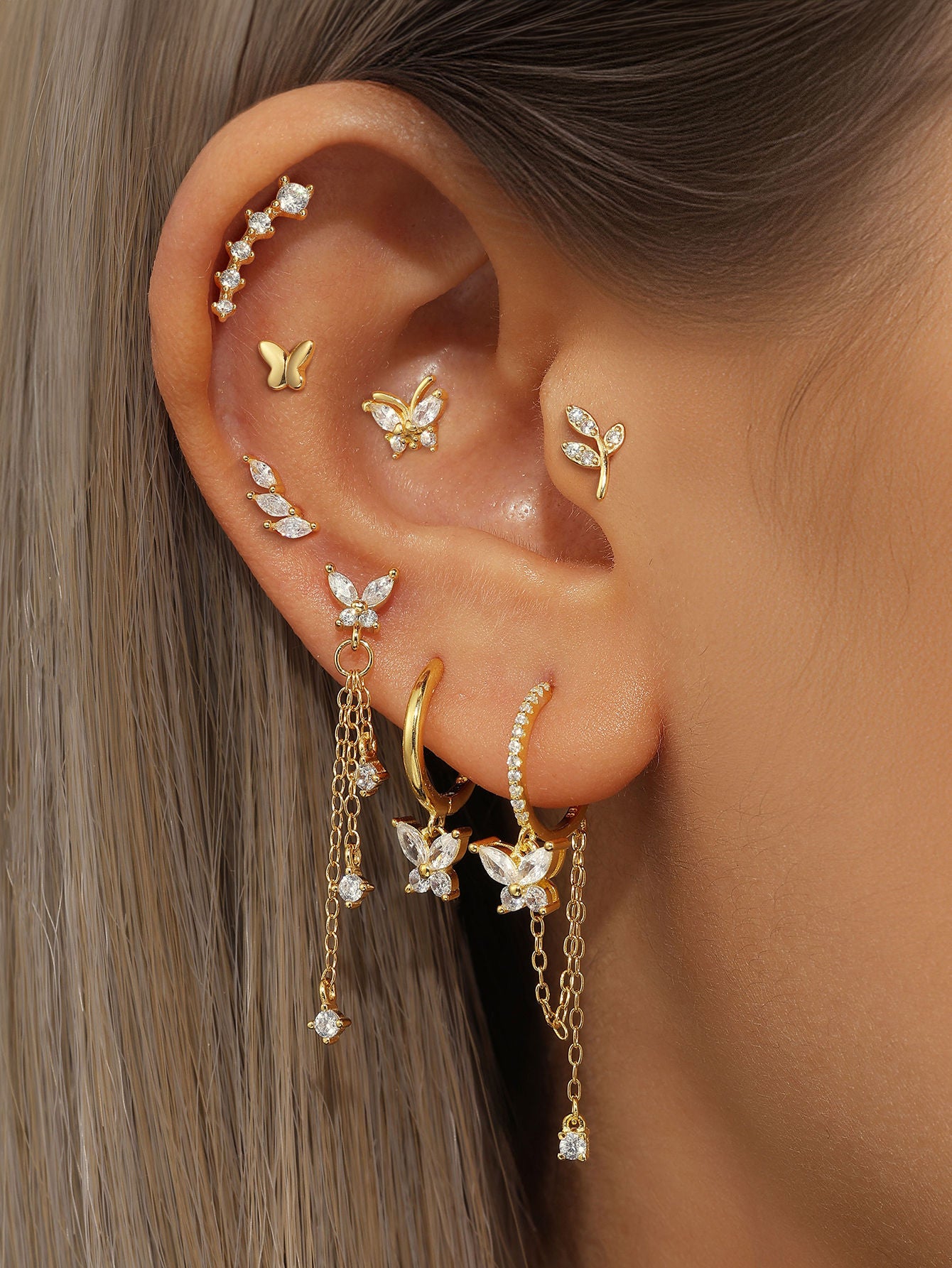 Collection of 18k gold plated sterling silver butterfly and leaf earrings with cubic zirconia for ear curation.