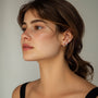 Model wearing three pairs of fashion 18k gold-plated Horse Eye Zircon earrings with cubic zirconia, styled on ear.