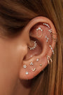 14K gold ear curation: sunburst daith hoop, crystal cuff, floral, heart, ball studs w/ AAAAA cubic zirconia.