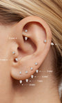 Women ear styling look wearing KOSINER 14K gold pear curved barbell cartilage hoop earring, multiple ear piercings stack delicate gold piercing jewelry daily wear