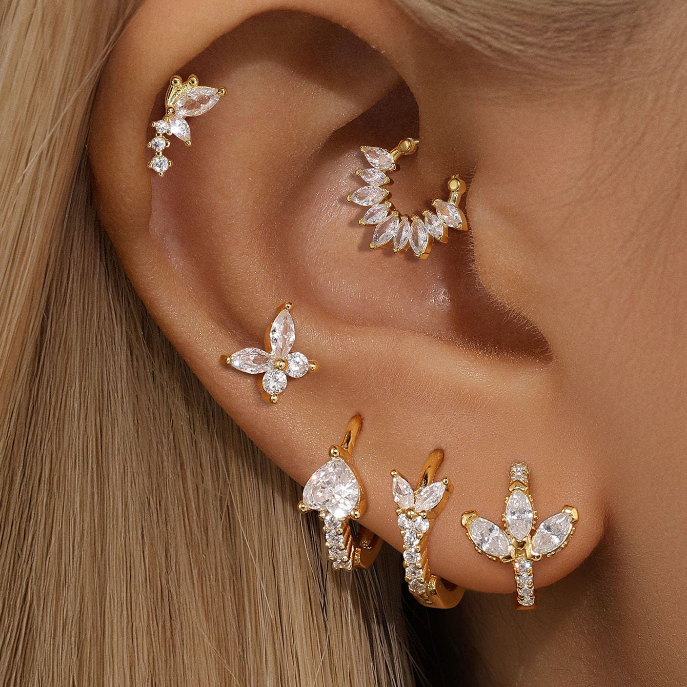 Gold-plated 925 sterling silver earring set featuring butterfly, flower, and leaf designs with cubic zirconia on ear.