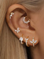 Gold 925 sterling silver butterfly stud with cubic zirconia, styled on ear with multiple earrings.
