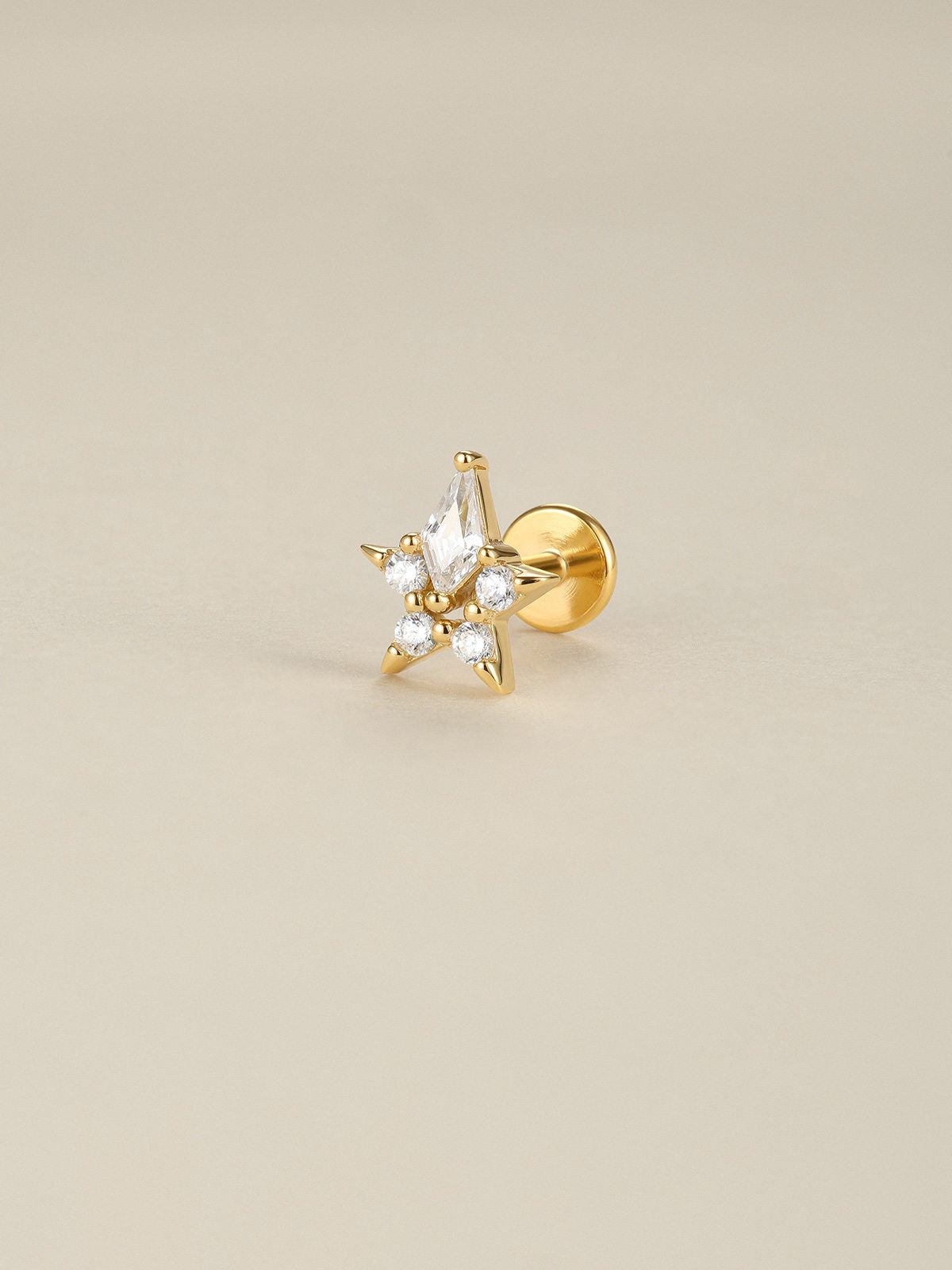 KOSINER Rising Star gold-plated Hollow Star flat back stud worn on the upper helix in a celestial ear stack
