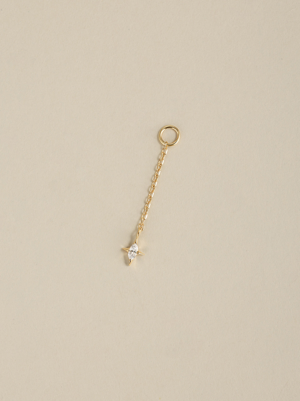 14K solid gold marquise cz star long chain dangle charm, KOSINER detachable piercing ear charm on neutral beige background
