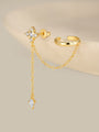 KOSINER Rising Star gold-plated star and moon chain earring and ear cuff worn on the left ear with celestial jewelry