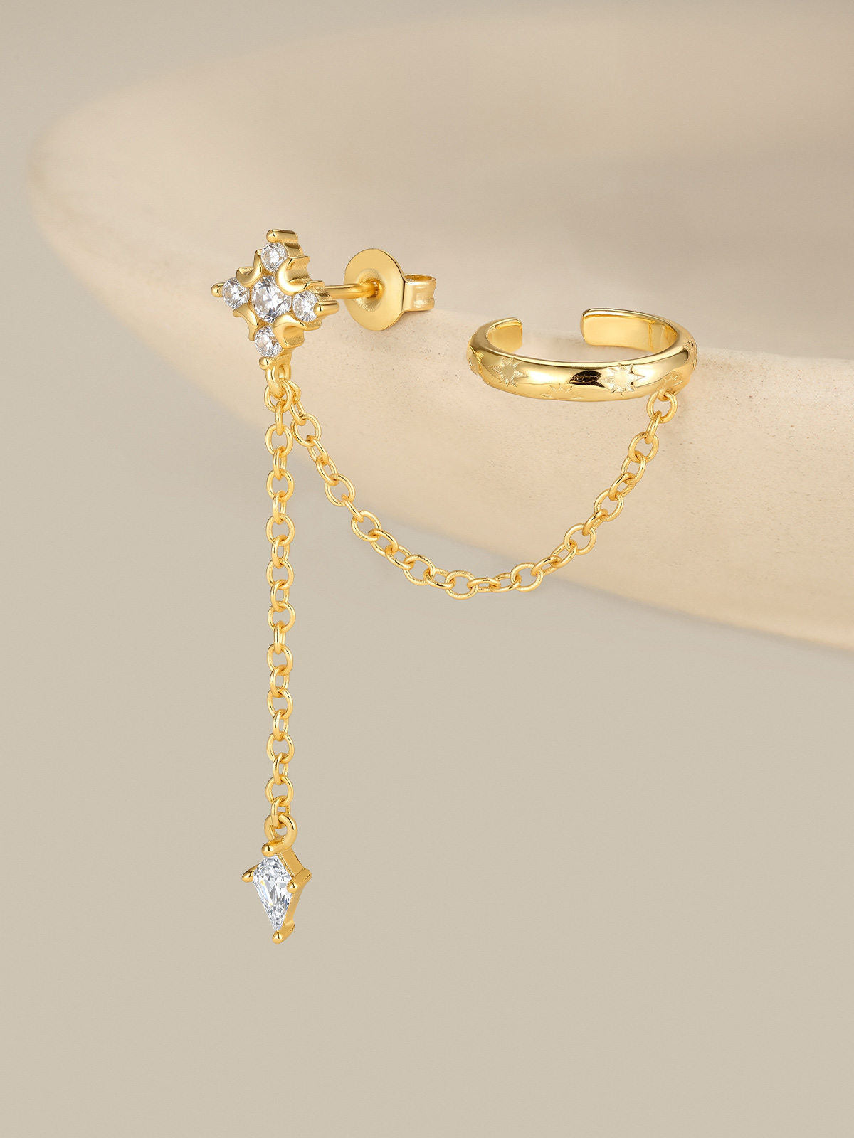 KOSINER Rising Star gold-plated star and moon chain earring and ear cuff worn on the left ear with celestial jewelry