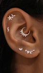 KOSINER ear stacking look with assorted KOSINER 14K solid gold heart-shaped cartilage piercing studs, multi-position helix lobe layered ear jewelry styling