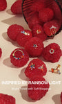 KOSINER Inspired by Rainbow Light full colorful gem piercing collection laid on fresh raspberries, blooming starburst flower studs, floral studs and clicker hoops