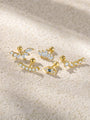 Five gold-plated sterling silver CZ stud earrings: marquise, flower, leaf, curved bar, and evil eye designs. Product variations.