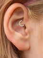 18K gold plated sterling silver daith piercing jewelry with double row of cubic zirconia stones on ear.
