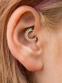 18K gold plated sterling silver daith piercing jewelry with double row of cubic zirconia stones on ear.