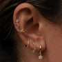 Gold plated sterling silver ear cuff and CZ flower stud, showcasing styling options.
