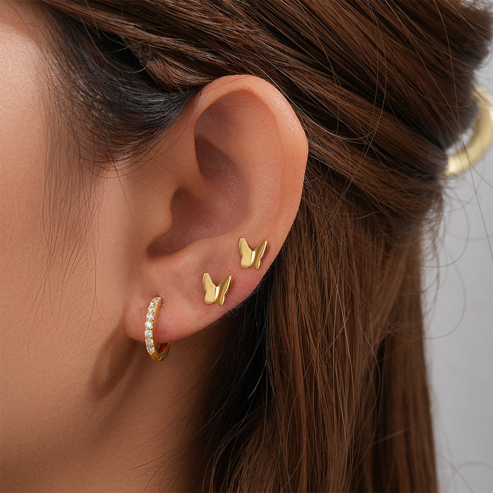 3 Pc Gold Zircon Mixed Earring Set with two butterfly studs and one CZ hoop on ear.