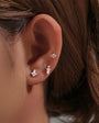 Three 18k gold plated sterling silver CZ flat back labret studs on ear.