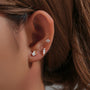 Three 18k gold plated sterling silver CZ flat back labret studs on ear.