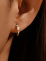 18K gold plated sterling silver hoop earring with marquise opal and cubic zirconia stones, shown on ear.