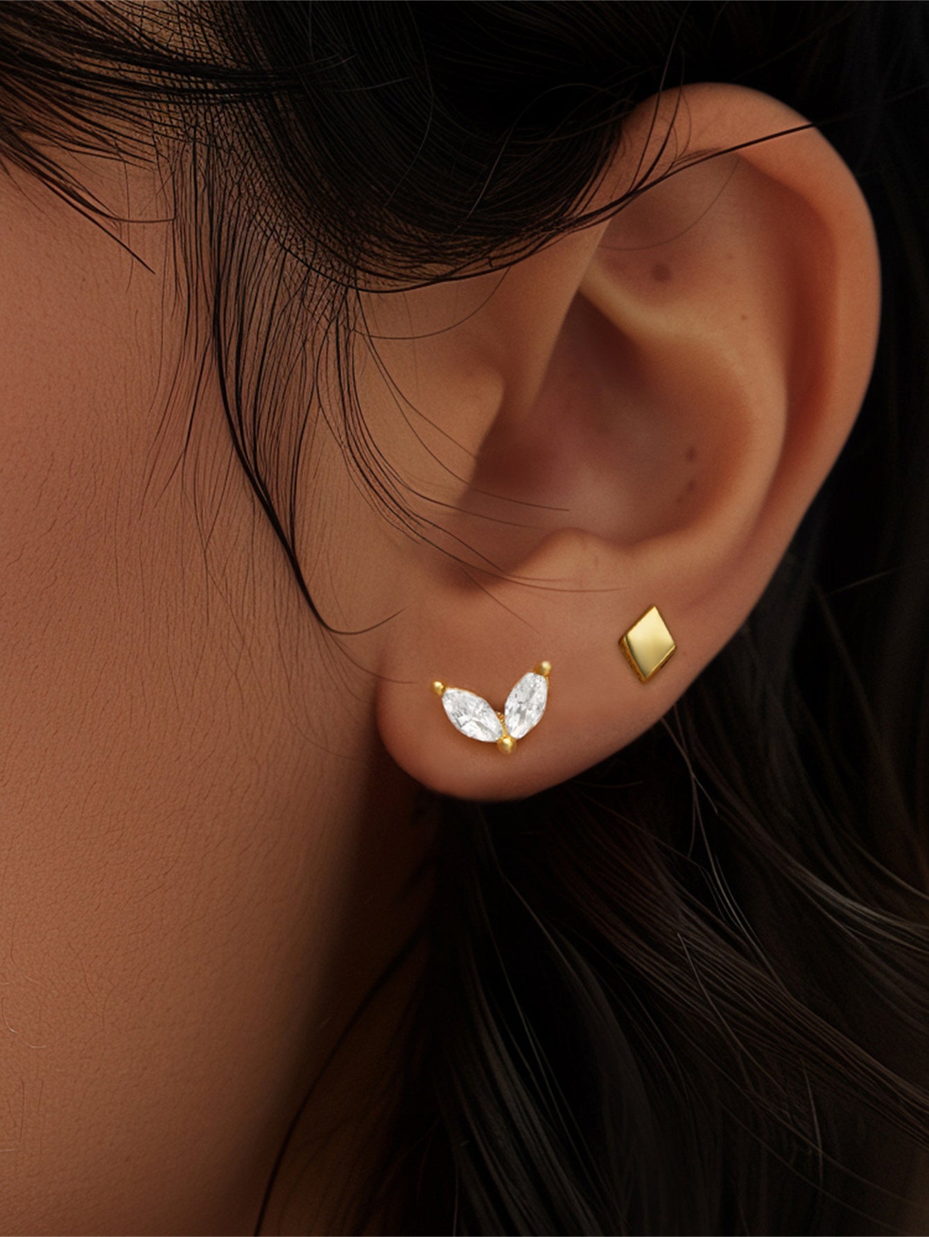 18kt gold sterling silver sprout stud with marquise CZ and diamond stud on ear.