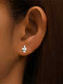 Sterling silver leaf ear stud with marquise cubic zirconia, worn on ear, showcasing size.
